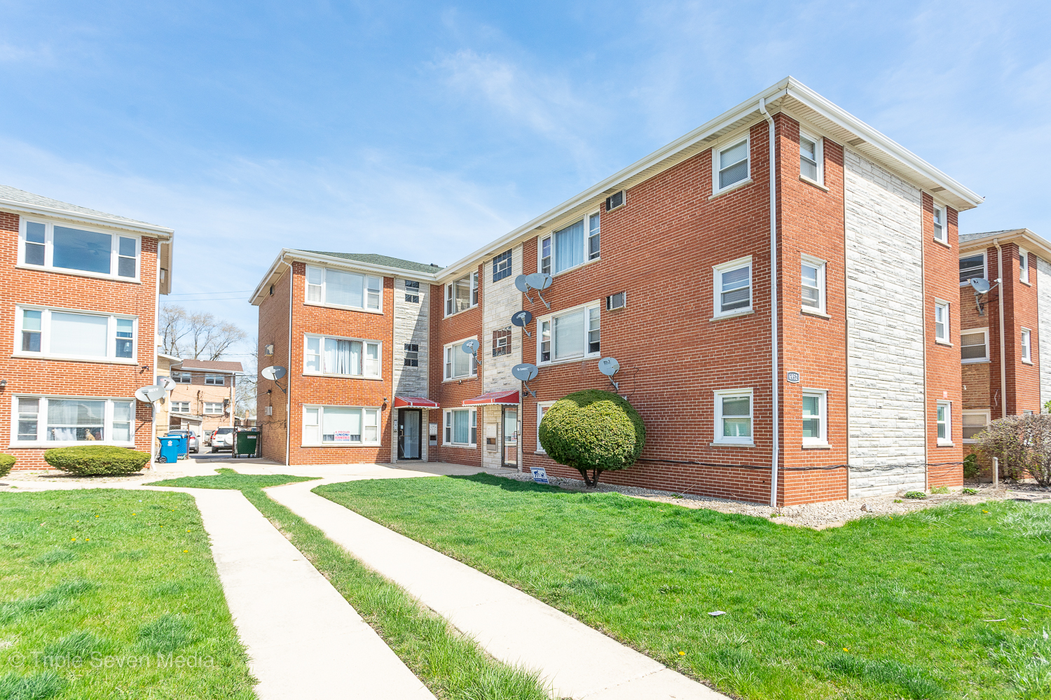 6952 West 65th Street, Unit 3C Chicago, IL 60638 - Photo 1 of 17 a front view of a house with a yard