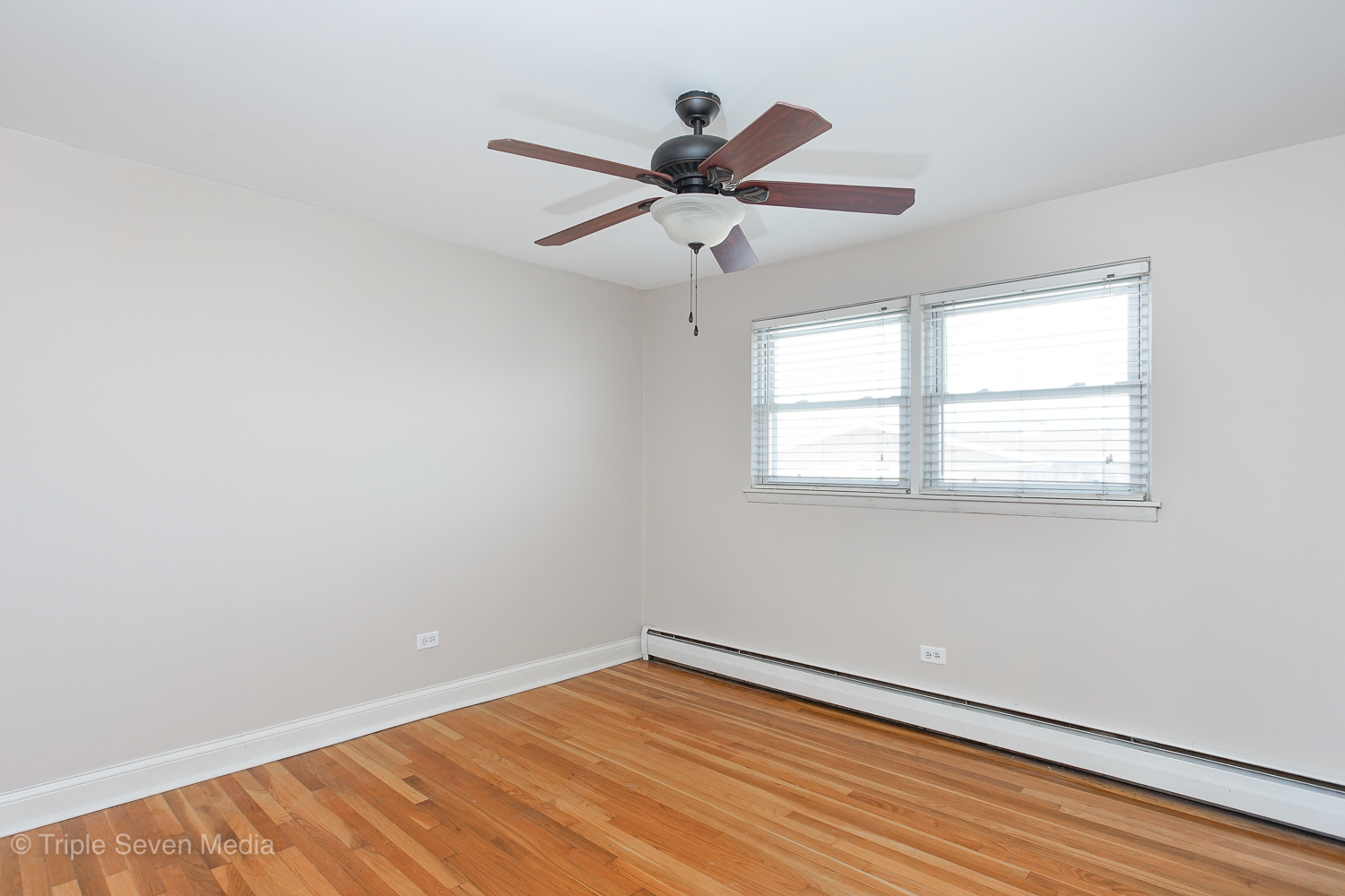 6952 West 65th Street, Unit 3C Chicago, IL 60638 - Photo 6 of 17 wooden floor in an empty room with a window