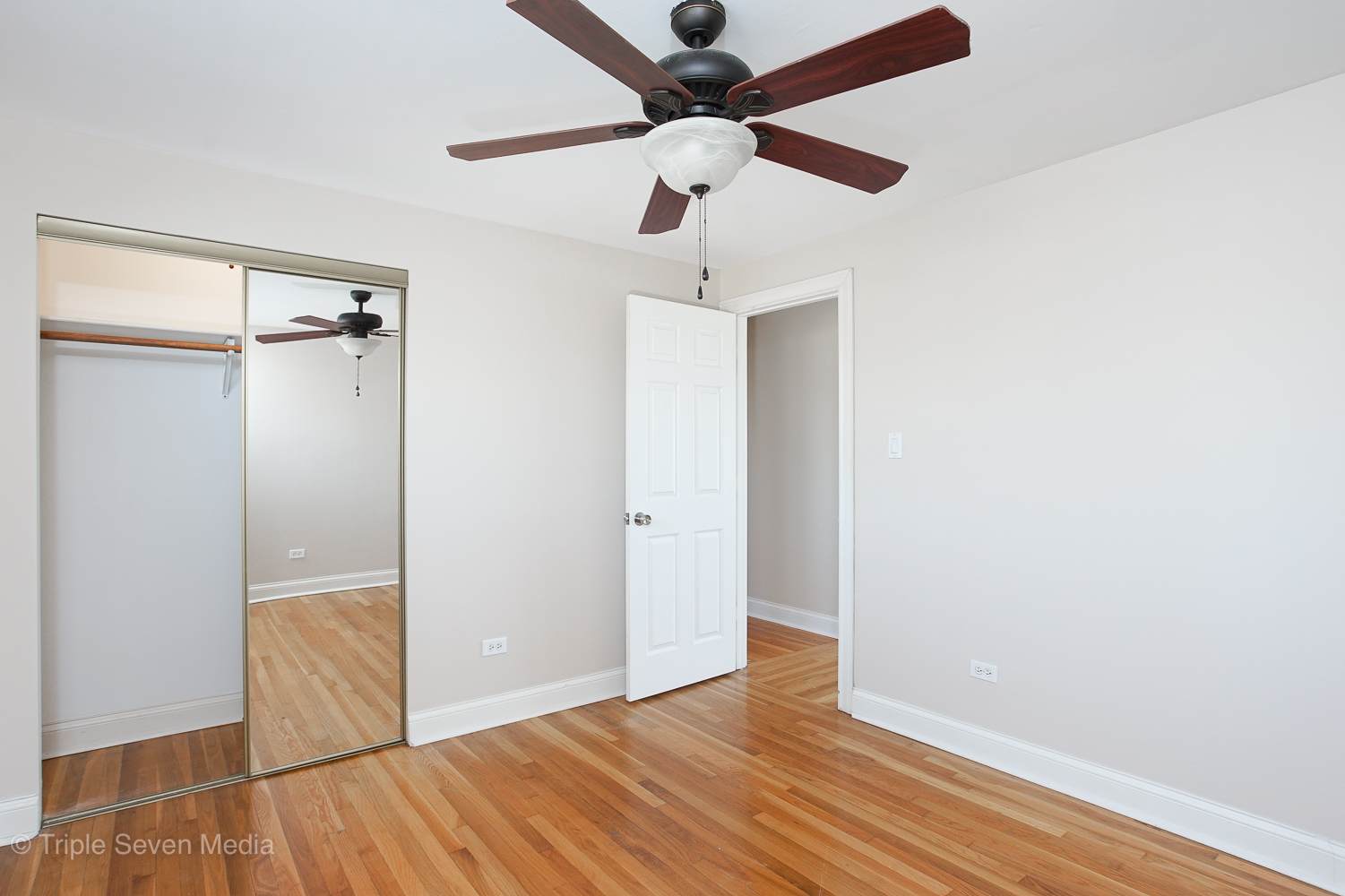 6952 West 65th Street, Unit 3C Chicago, IL 60638 - Photo 7 of 17 an empty room with wooden floor closet and fan