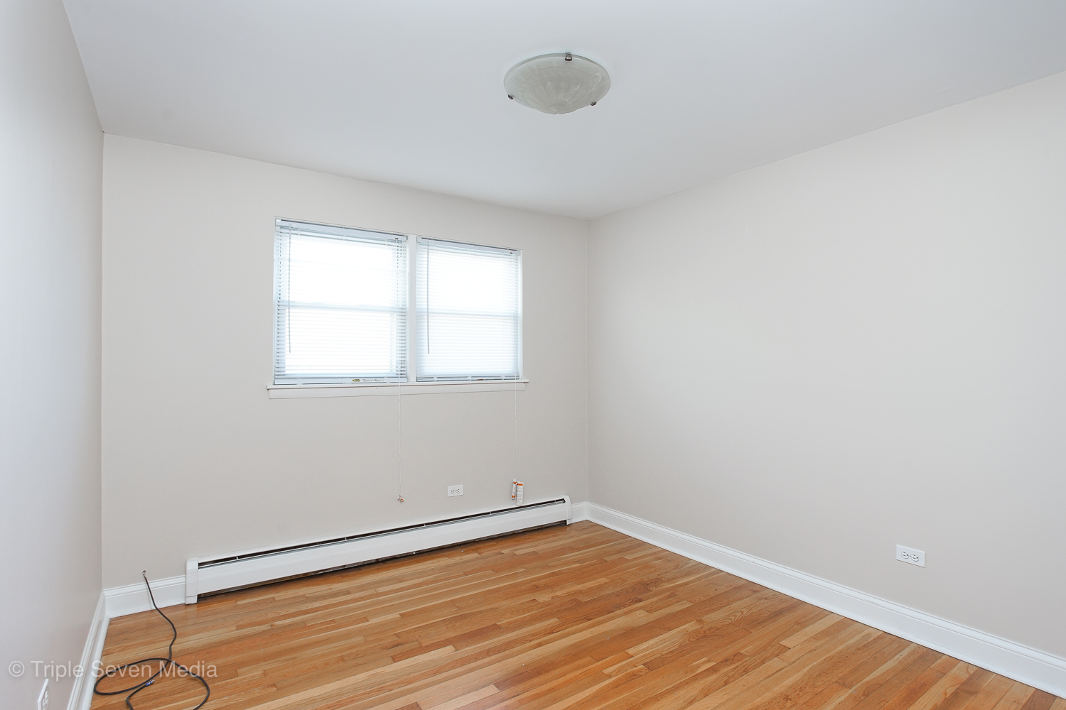 6952 West 65th Street, Unit 3C Chicago, IL 60638 - Photo 8 of 17 a view of an empty room with wooden floor and a window