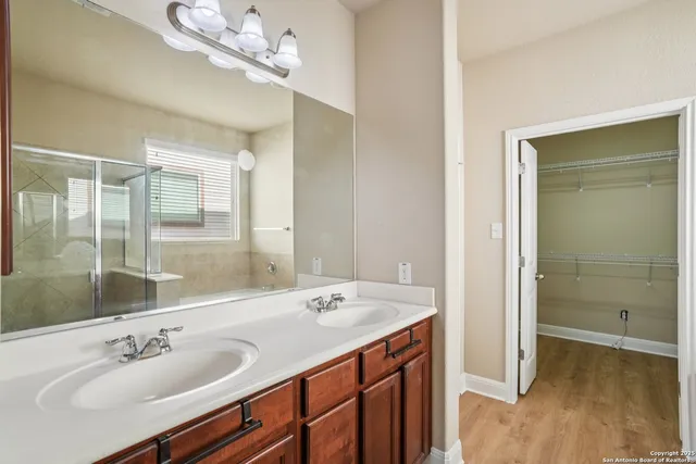 a bathroom with a sink double vanity and a mirror