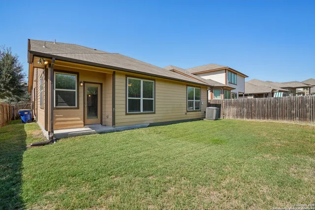 a view of a backyard with a garden and entertaining space