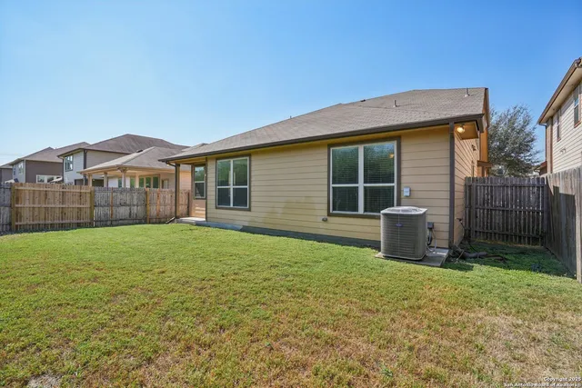 a view of a house with a backyard and a garden
