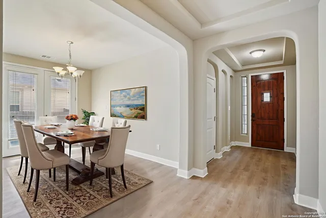 a view of a dining room with furniture and wooden floor