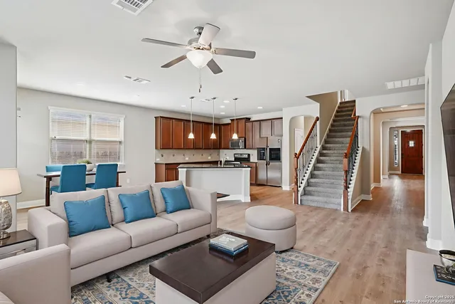 a living room with furniture and wooden floor