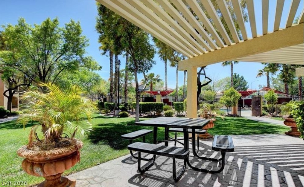 7885 West Flamingo Road, Unit 1008 Las Vegas, NV 89147 - Photo 6 of 29 Relax and dine alfresco under the inviting shade of the outdoor patio's charming pergola.