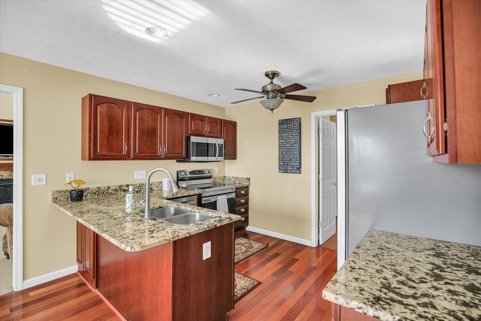 4619 Copper Ridge Road Champaign, IL 61822 - Photo 12 of 29 a kitchen with stainless steel appliances granite countertop a sink stove and refrigerator