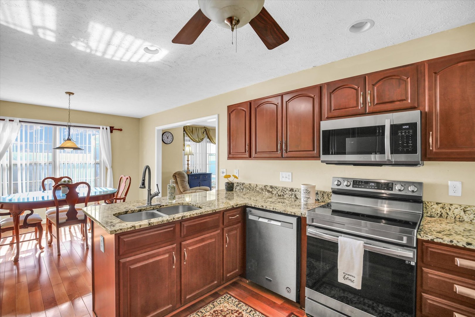 4619 Copper Ridge Road Champaign, IL 61822 - Photo 13 of 29 a kitchen with stainless steel appliances granite countertop a stove and a sink