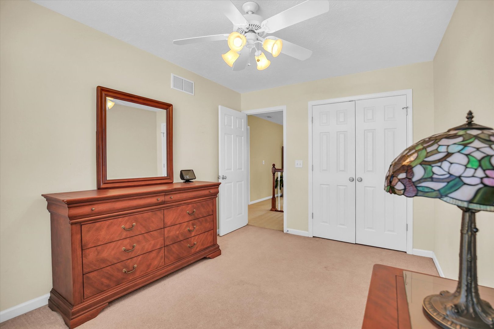 4619 Copper Ridge Road Champaign, IL 61822 - Photo 21 of 29 a room with a bed and a dresser