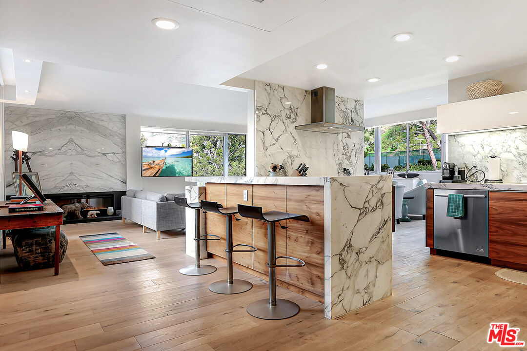 a living room with furniture and a dining table with kitchen view