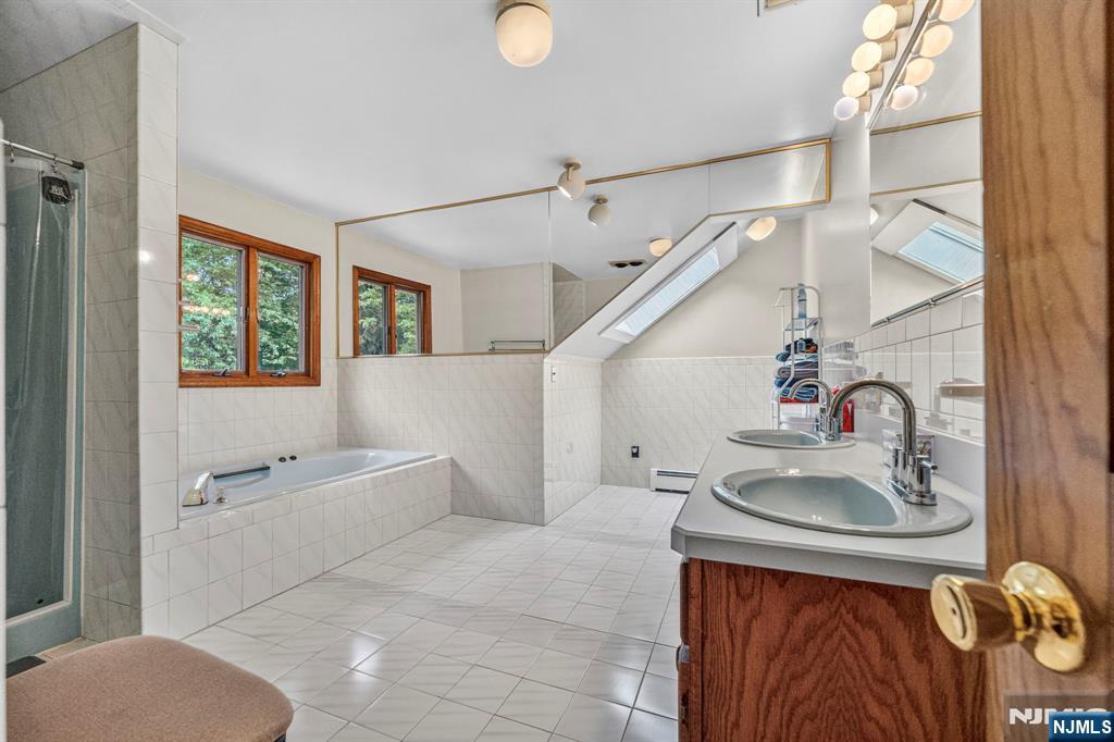 5110 Berkshire Valley Road Oak Ridge, NJ 07438 - Photo 36 of 49 a bathroom with a sink a toilet and shower