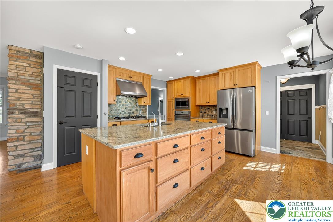 202 Cherry Court Nazareth, PA 18064 - Photo 14 of 43 a kitchen with stainless steel appliances granite countertop a refrigerator and a stove top oven
