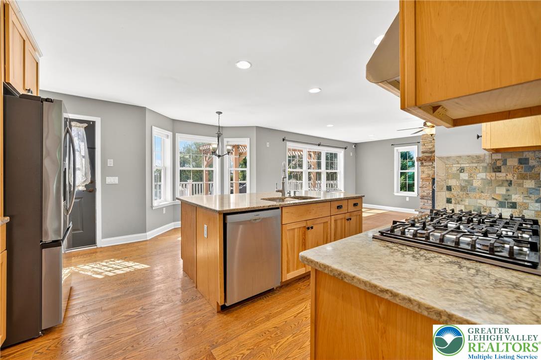 202 Cherry Court Nazareth, PA 18064 - Photo 17 of 43 a kitchen with stainless steel appliances granite countertop a sink stove and refrigerator