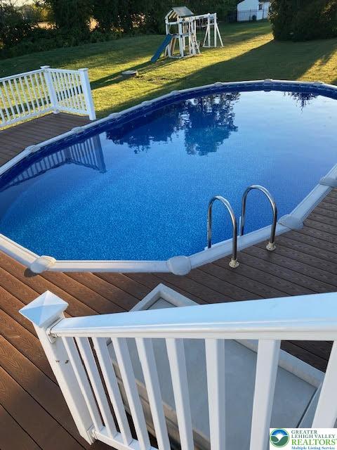 202 Cherry Court Nazareth, PA 18064 - Photo 41 of 43 a view of swimming pool with seating area and trees in the background
