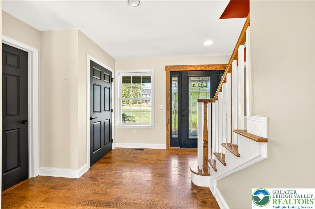 202 Cherry Court Nazareth, PA 18064 - Photo 7 of 43 a view of a hallway with wooden floor and a living room