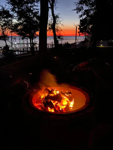 a view of a swimming pool with an outdoor space and a fire pit