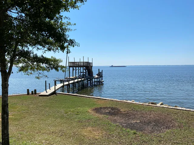 a view of a swimming pool with an outdoor seating and a yard