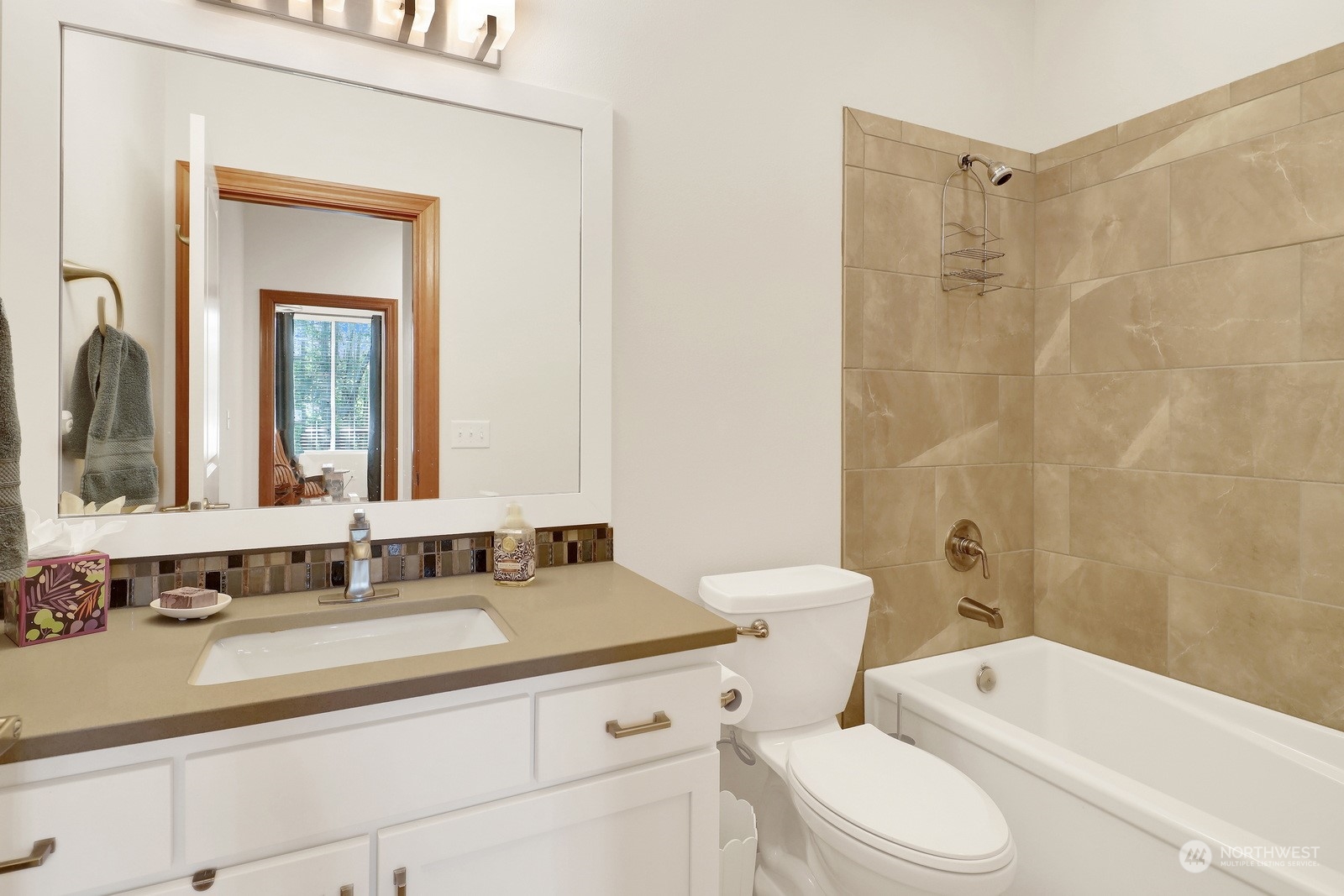 734 Fuchsia Loop Bellingham, WA 98226 - Photo 18 of 27 a bathroom with a granite countertop sink toilet a mirror and bathtub