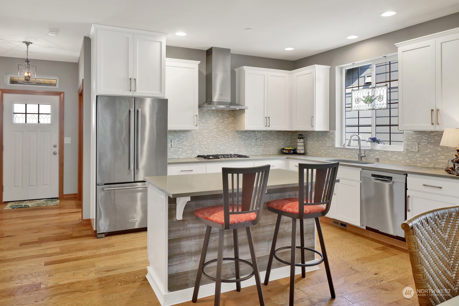734 Fuchsia Loop Bellingham, WA 98226 - Photo 7 of 27 a kitchen with stainless steel appliances granite countertop a dining table chairs refrigerator and sink