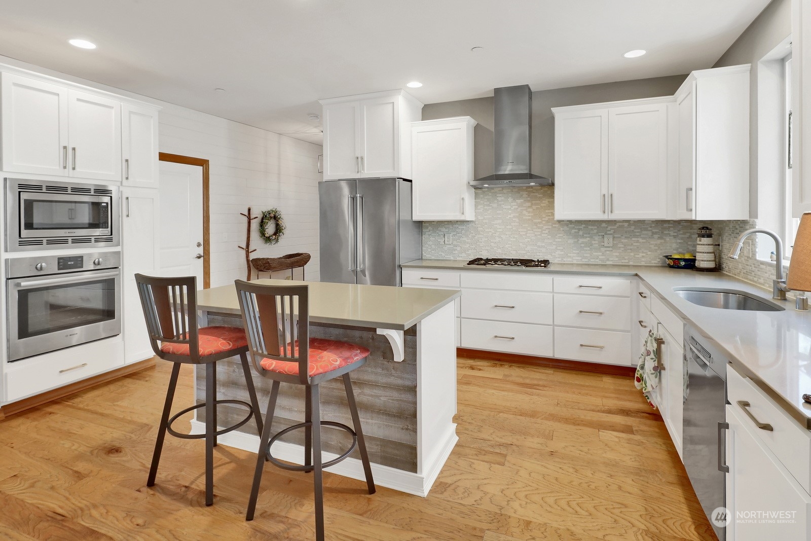 734 Fuchsia Loop Bellingham, WA 98226 - Photo 8 of 27 a kitchen with stainless steel appliances kitchen island granite countertop a table chairs microwave and sink