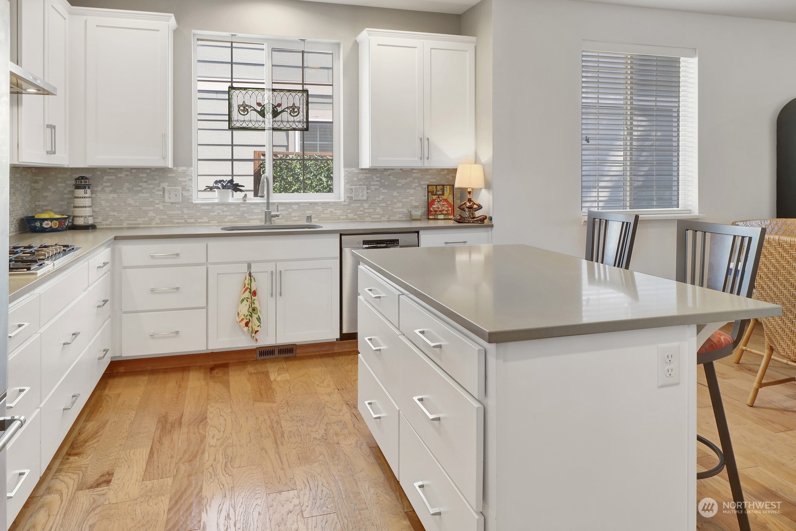 734 Fuchsia Loop Bellingham, WA 98226 - Photo 9 of 27 a kitchen with a stove a sink and white cabinets