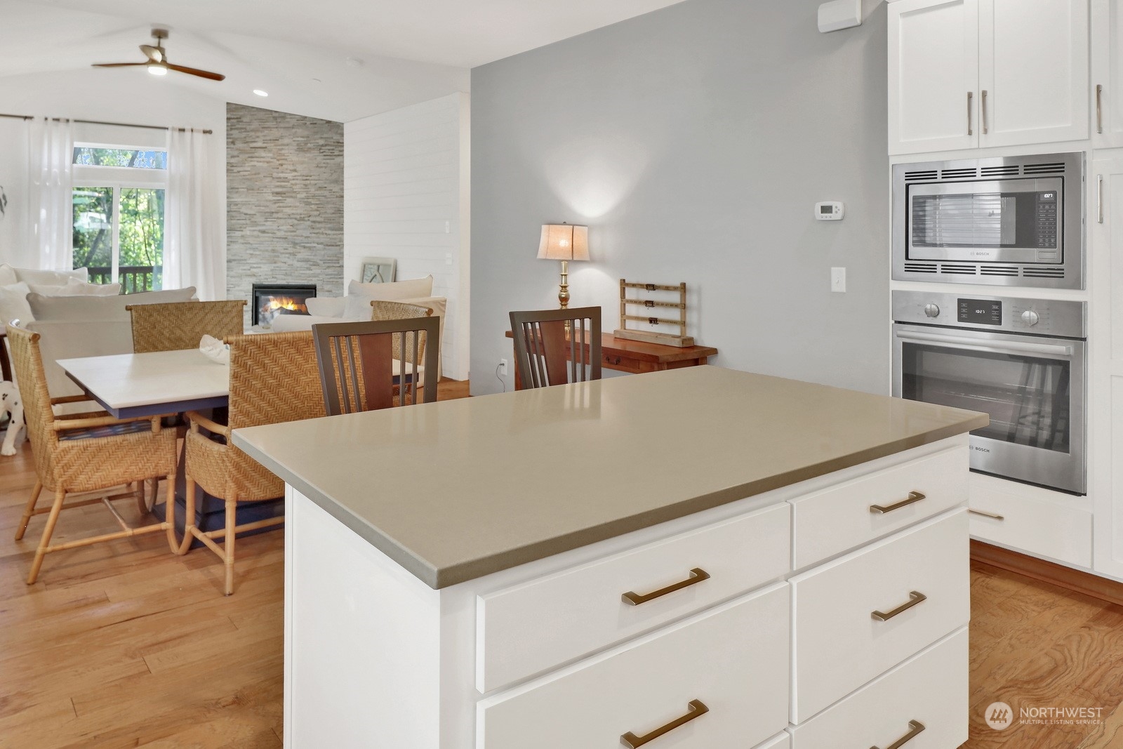 734 Fuchsia Loop Bellingham, WA 98226 - Photo 10 of 27 a kitchen with a table chairs microwave and cabinets