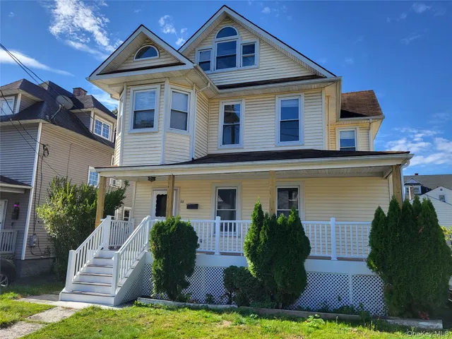 a front view of a house with a yard garage and outdoor seating