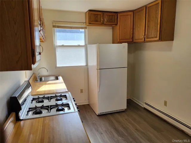 a kitchen with a refrigerator and a stove