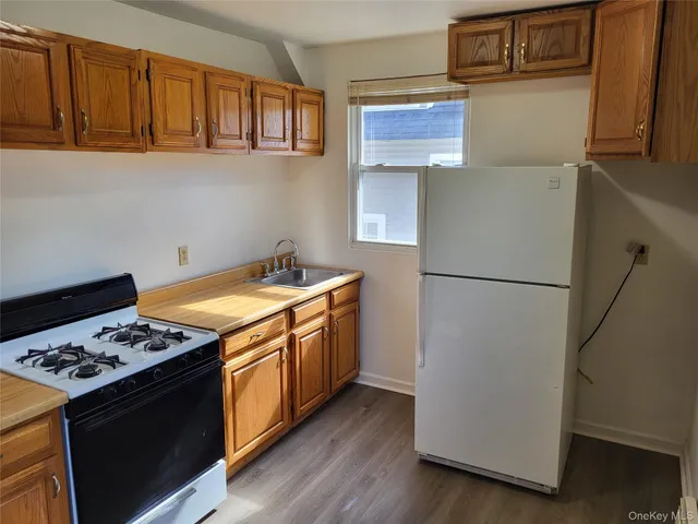 a kitchen with stainless steel appliances granite countertop a refrigerator stove a sink dishwasher and microwave