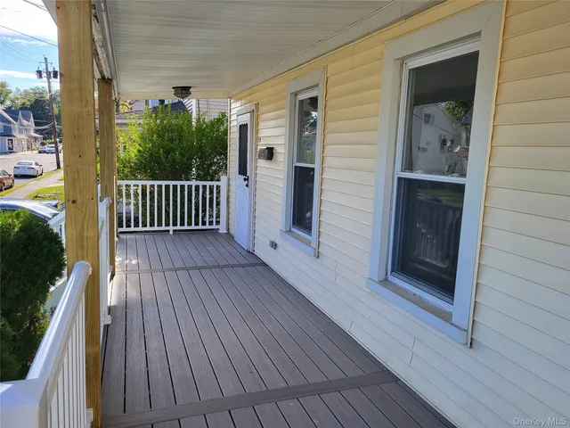 a view of balcony with wooden floor
