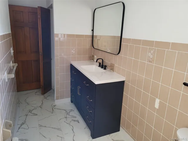 a bathroom with a sink vanity and a mirror