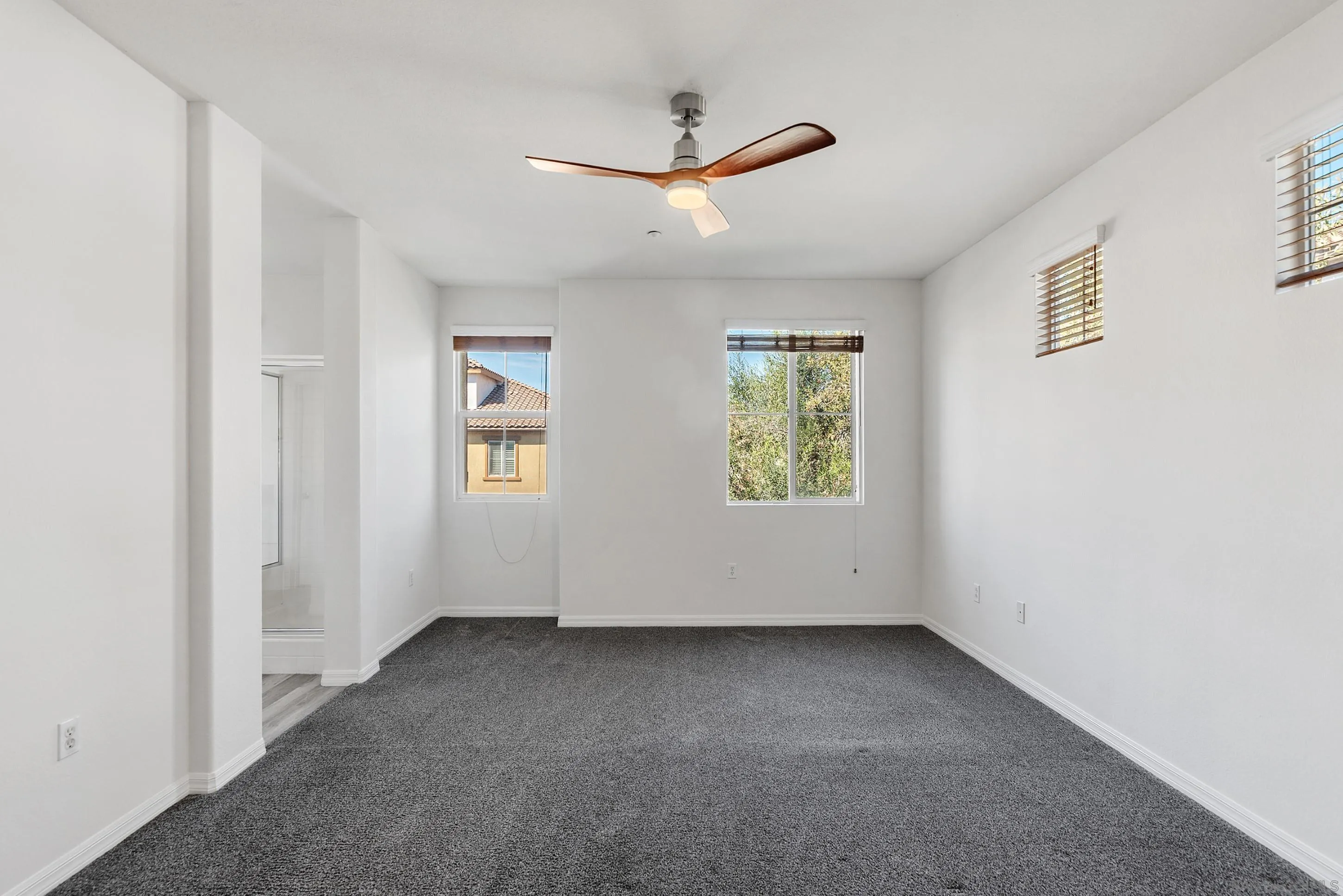 2185 Caminito Rinaldo, Unit 118 Chula Vista, CA 91915 - Photo 13 of 38 an empty room with windows and ceiling fan