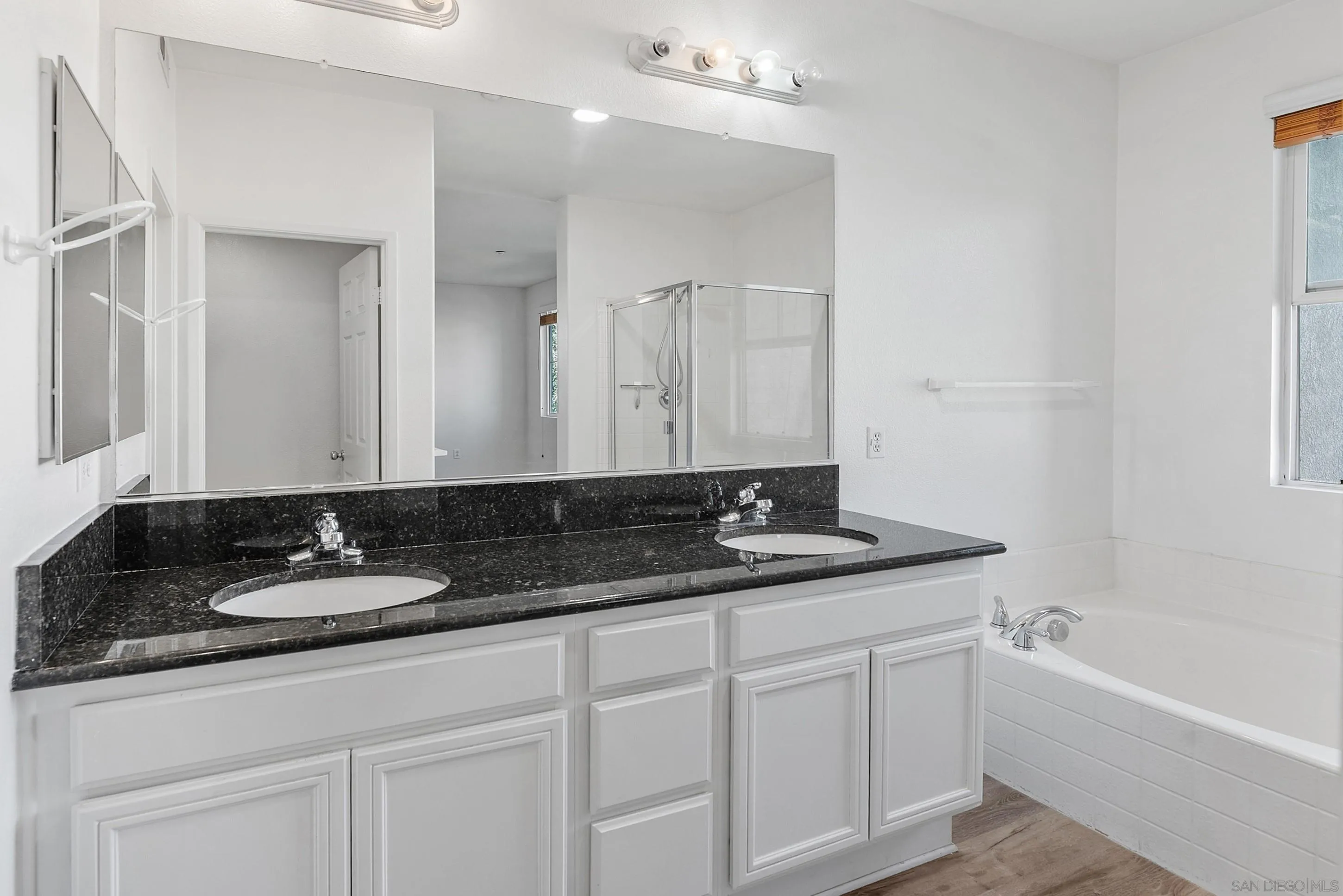 2185 Caminito Rinaldo, Unit 118 Chula Vista, CA 91915 - Photo 15 of 38 a bathroom with a granite countertop sink and a mirror
