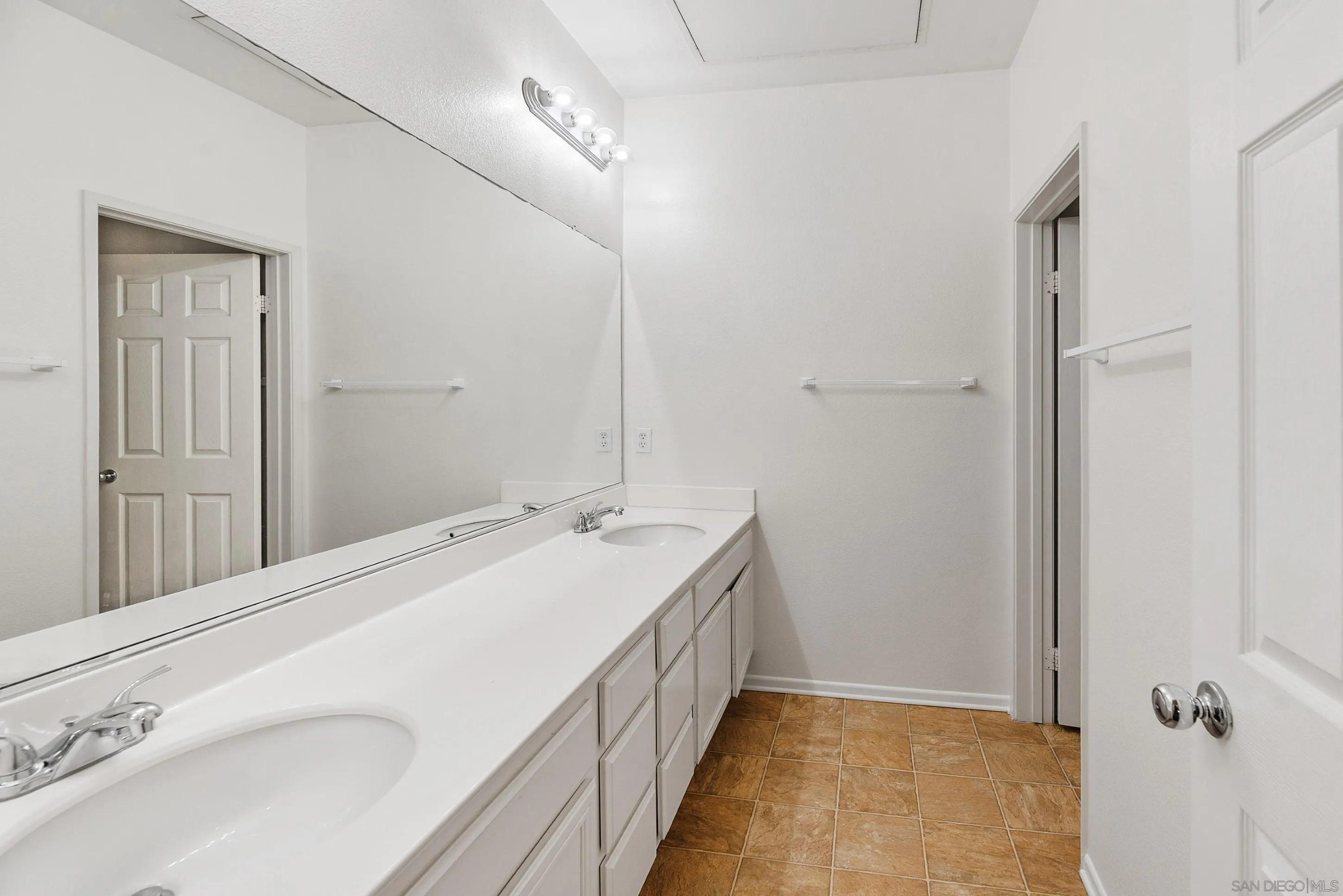 2185 Caminito Rinaldo, Unit 118 Chula Vista, CA 91915 - Photo 20 of 38 a bathroom with a double vanity sink and mirror