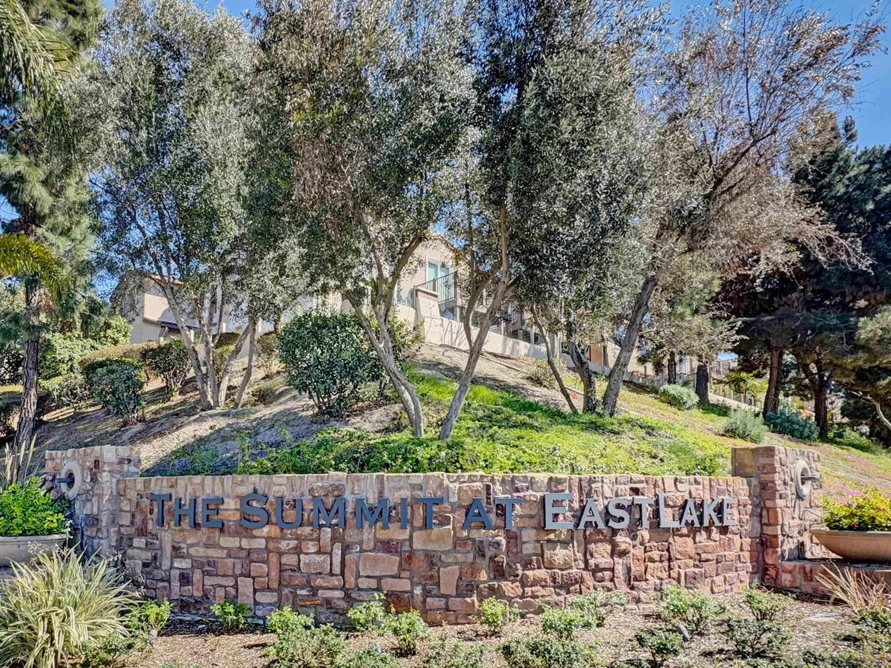2185 Caminito Rinaldo, Unit 118 Chula Vista, CA 91915 - Photo 27 of 38 a wooden fence with trees in the background