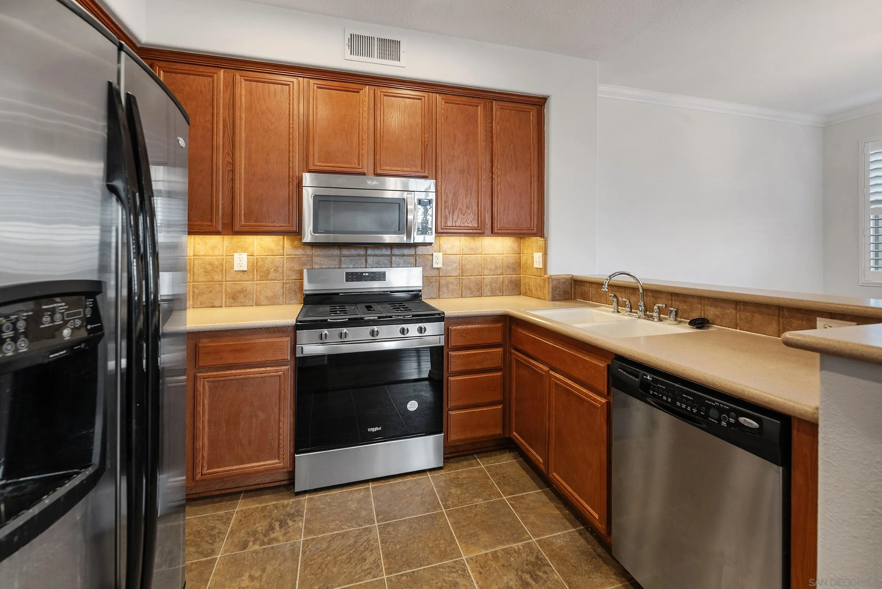 2185 Caminito Rinaldo, Unit 118 Chula Vista, CA 91915 - Photo 10 of 38 a kitchen with a sink stove and refrigerator