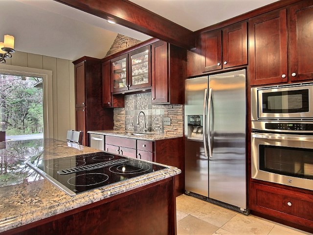 6232 Cunningham Road Rockford, IL 61102 - Photo 7 of 25 a kitchen with stainless steel appliances granite countertop a stove a refrigerator and a microwave