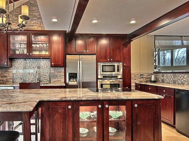 6232 Cunningham Road Rockford, IL 61102 - Photo 10 of 25 a kitchen with stainless steel appliances granite countertop wooden cabinets a refrigerator and a sink