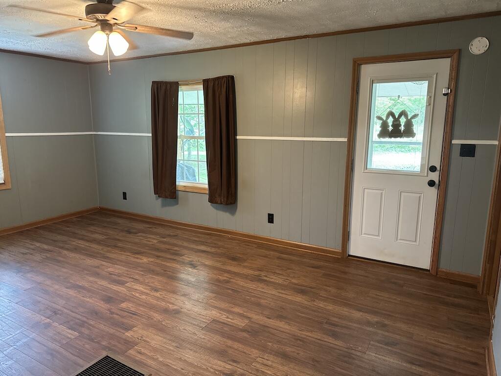 2638 Castleton Road Max Meadows, VA 24360 - Photo 7 of 46 an empty room with wooden floor fan and windows