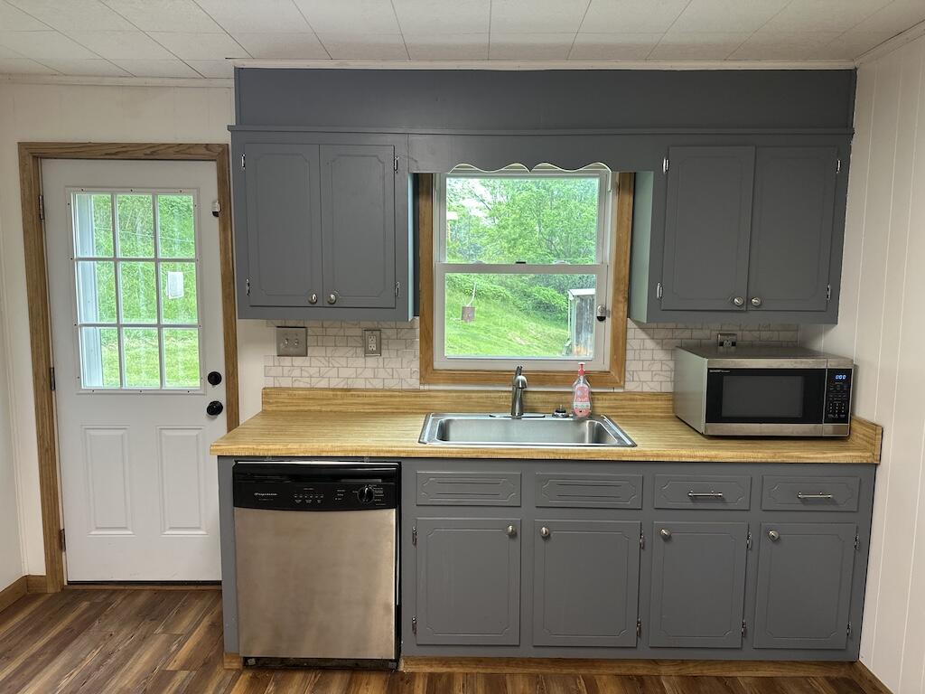 2638 Castleton Road Max Meadows, VA 24360 - Photo 9 of 46 a kitchen with stainless steel appliances granite countertop a sink a stove and a wooden cabinets