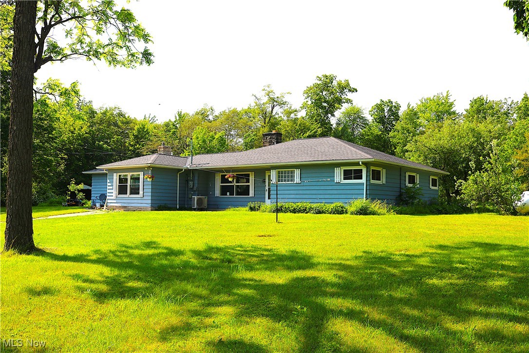 14485 Bass Lake Road Newbury, OH 44065 - Photo 1 of 22 View of front of house featuring a chimney and a front lawn