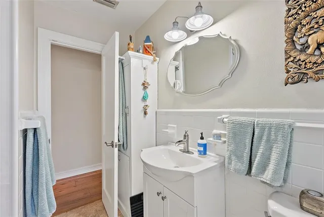 a bathroom with a sink a mirror and a shower curtain
