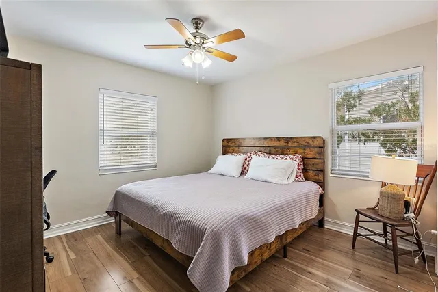 a bedroom with a bed a table and chair