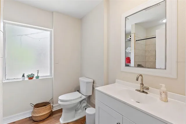 a bathroom with a toilet sink and mirror