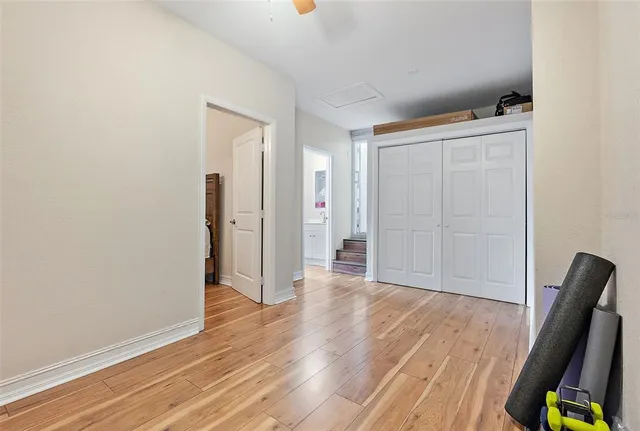 a view of a hallway with wooden floor and furniture