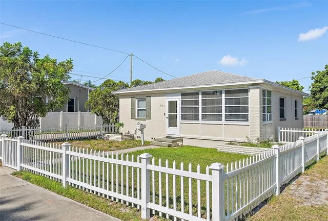 a front view of a house with a small yard