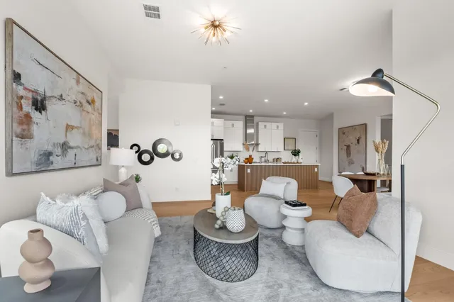 a living room with furniture and a large mirror