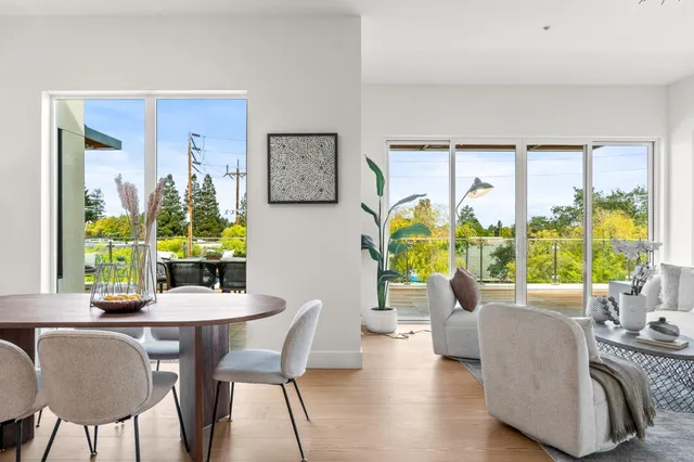 a dining room with furniture a chandelier and wooden floor