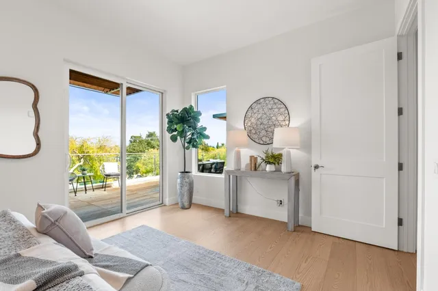 a living room with furniture a window and a chandelier