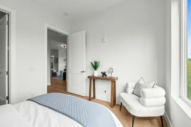 a bedroom with a bed and a chair